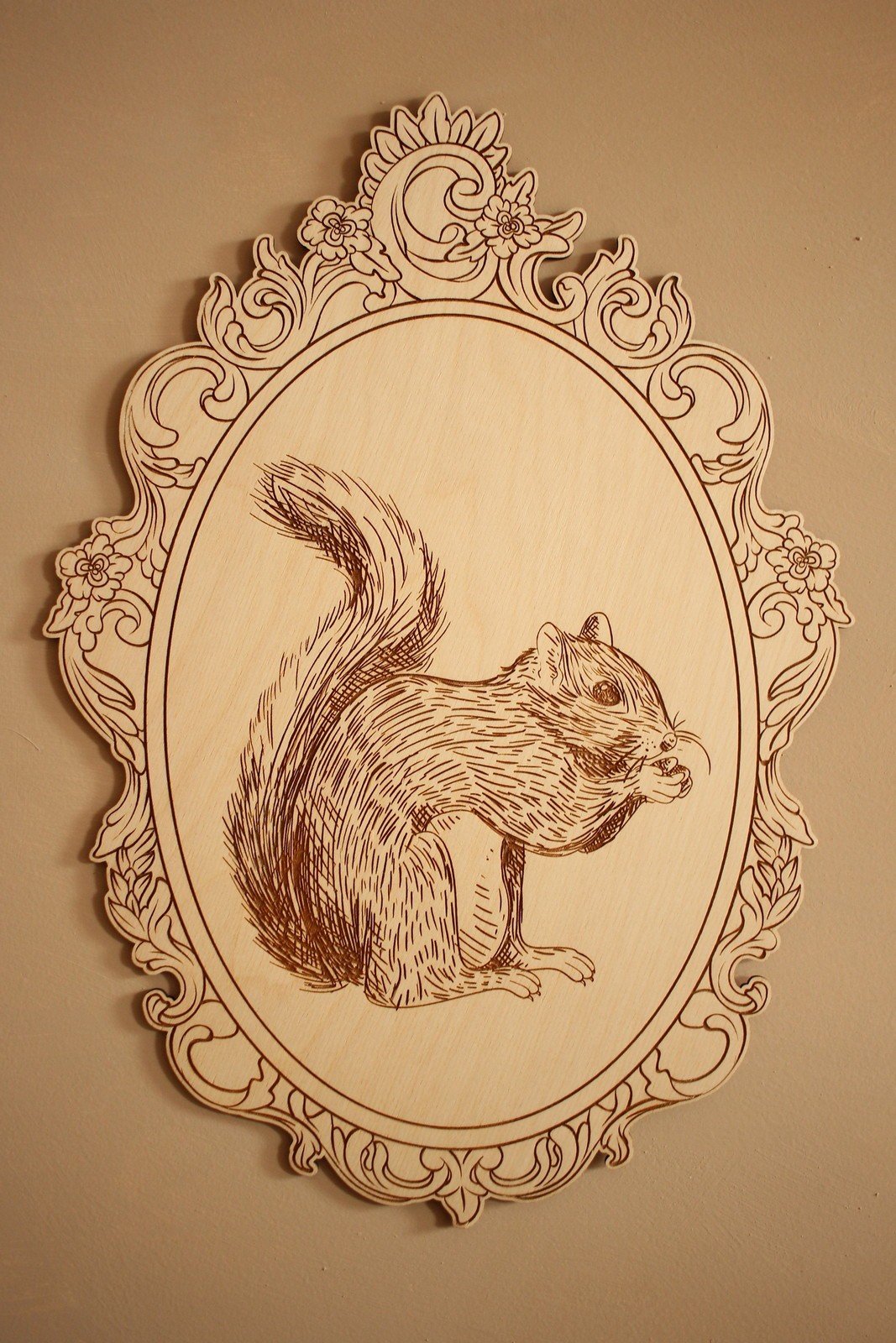 3. Close-up of engraved squirrel picture in ornate retro frame on wall