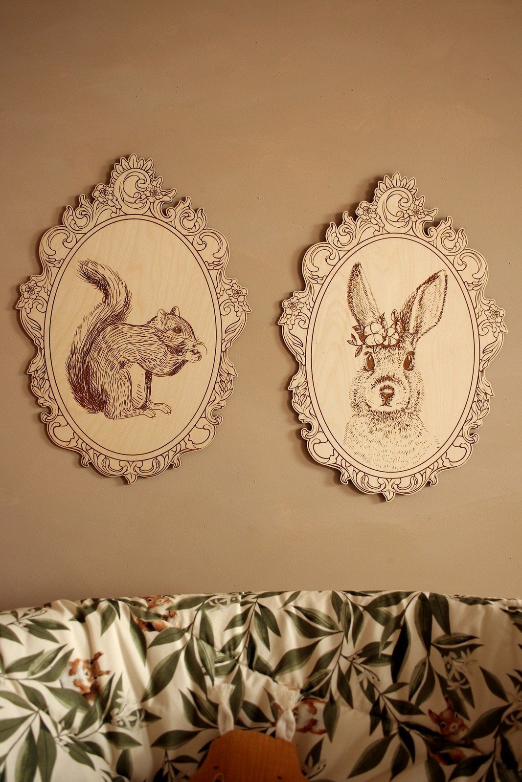 13. Engraved squirrel and rabbit pictures in retro frames on wall above floral-patterned couch