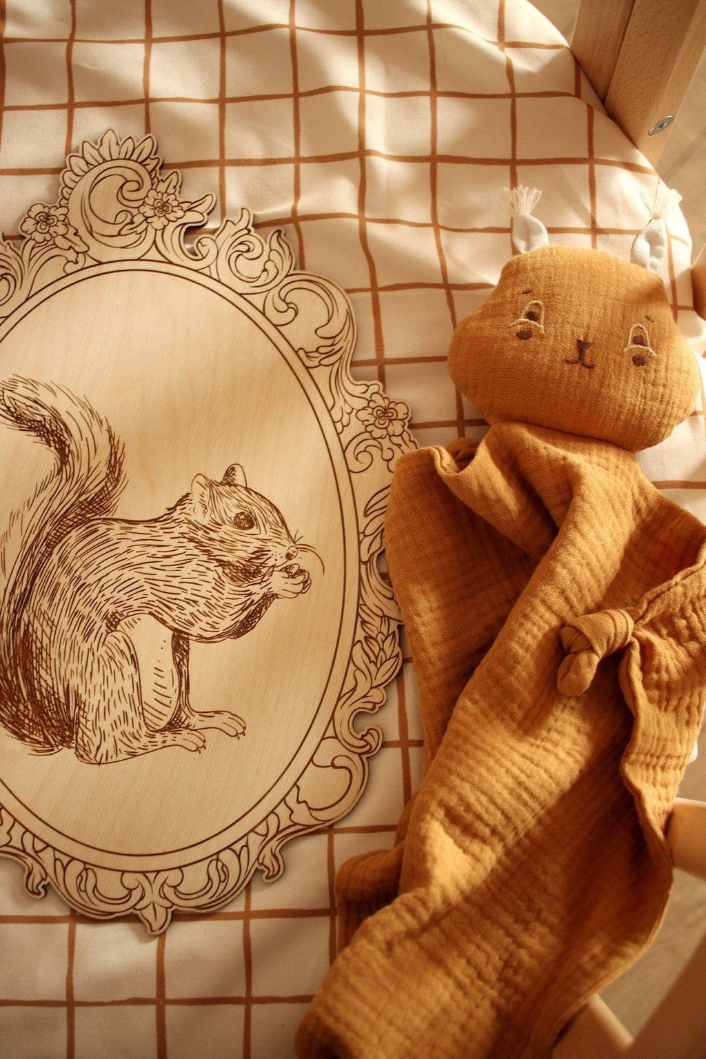 8. Engraved squirrel picture in retro frame on checkered fabric with plush toy