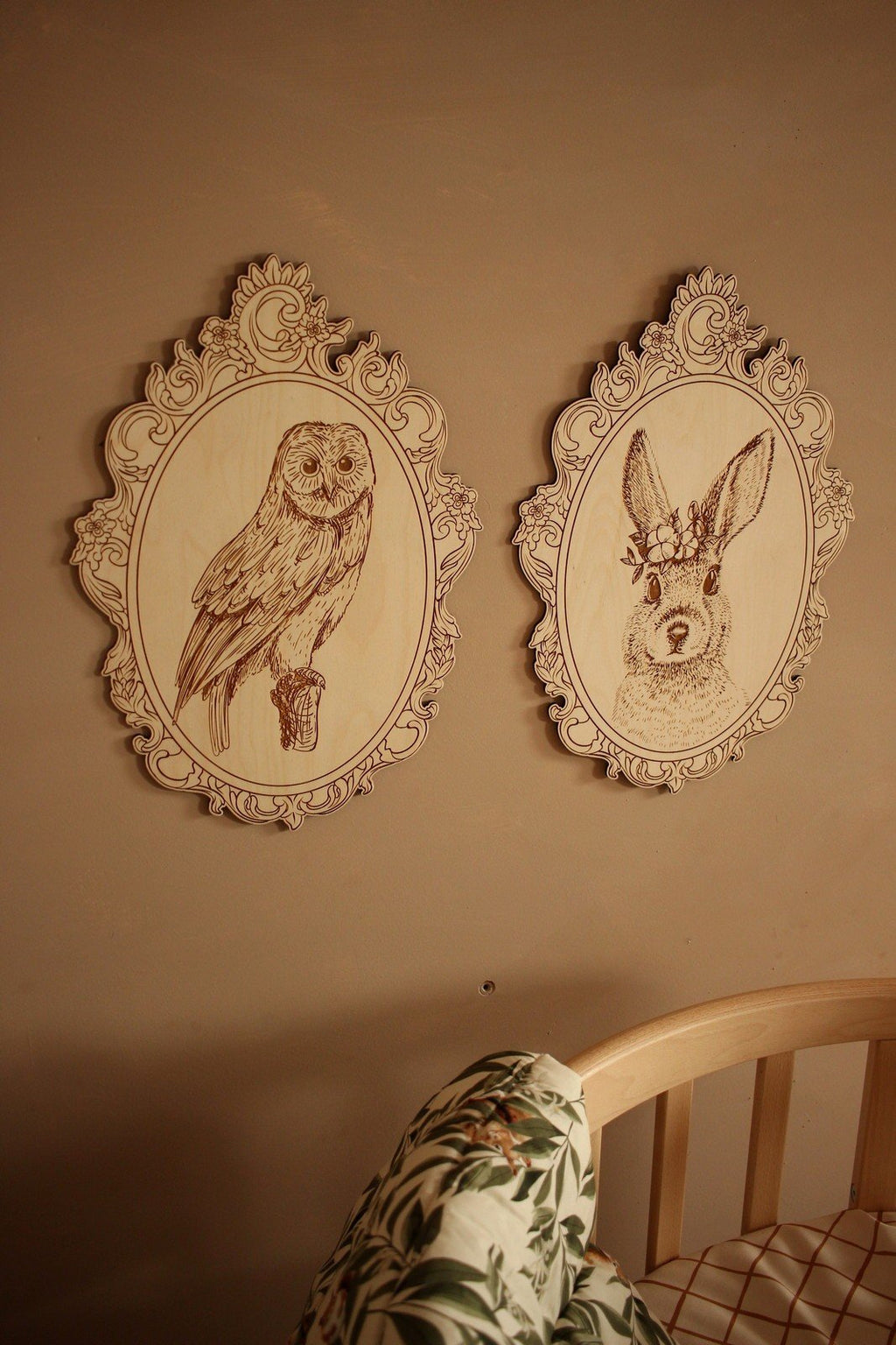 2. Engraved owl and rabbit pictures in retro frames on wall above floral-patterned couch