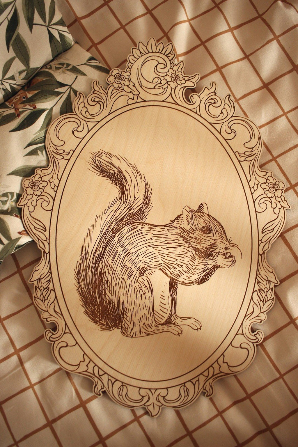 9. Engraved squirrel picture in retro frame on checkered fabric with floral pattern