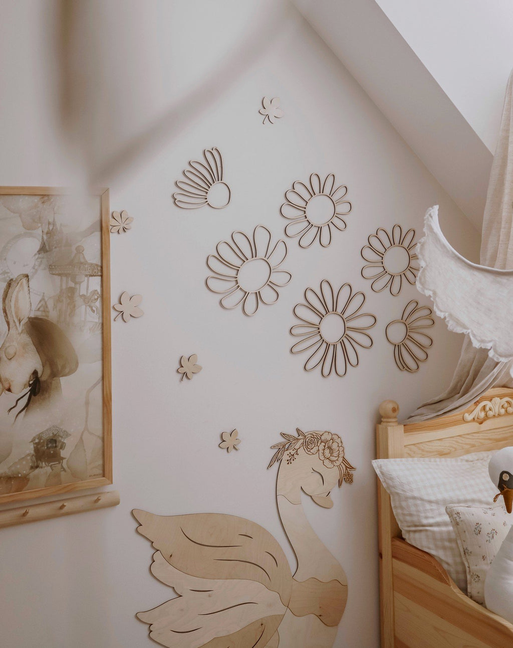 4. Natural plywood daisy wall decorations in a child's room with a swan-themed bed, enhancing the room's whimsical and natural aesthetic.