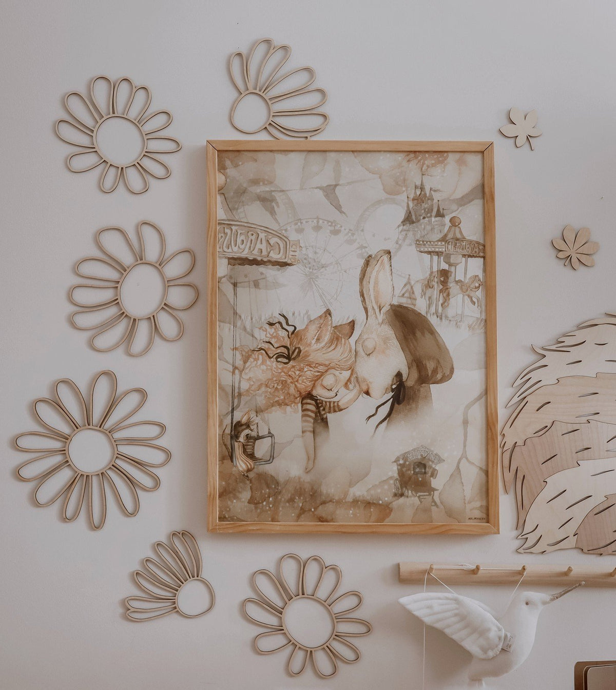 6. Natural plywood daisy wall decorations arranged around a framed picture in a child's room, contributing to a cozy and artistic environment.