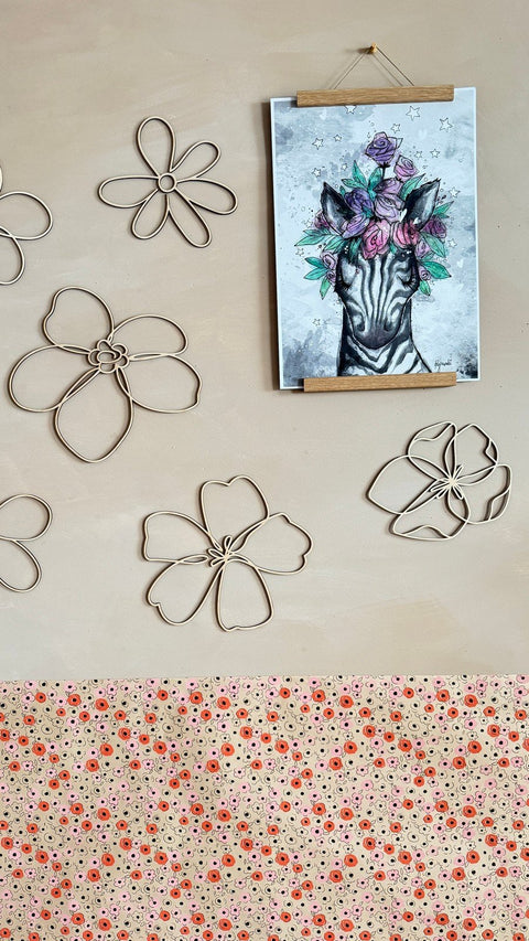 4. Close-up of six wooden flower wall decorations on a beige wall, next to a zebra art print, highlighting the natural plywood texture.
