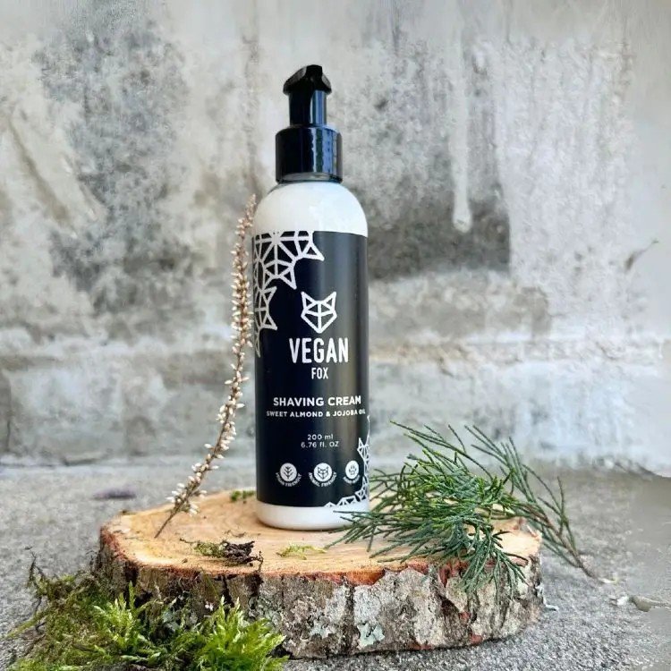 2. Vegan Fox men's shaving cream, 200ml, displayed on a wooden slice with natural elements in a rustic setting