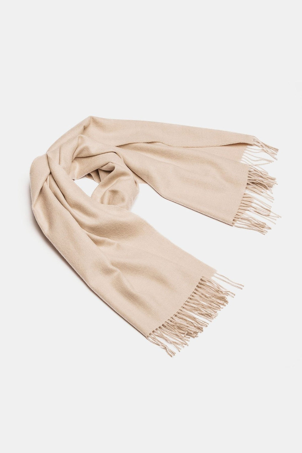 4. Studio shot of Alpaka natural baby alpaca maxi-scarf in light beige with fringes, displayed in a rolled style