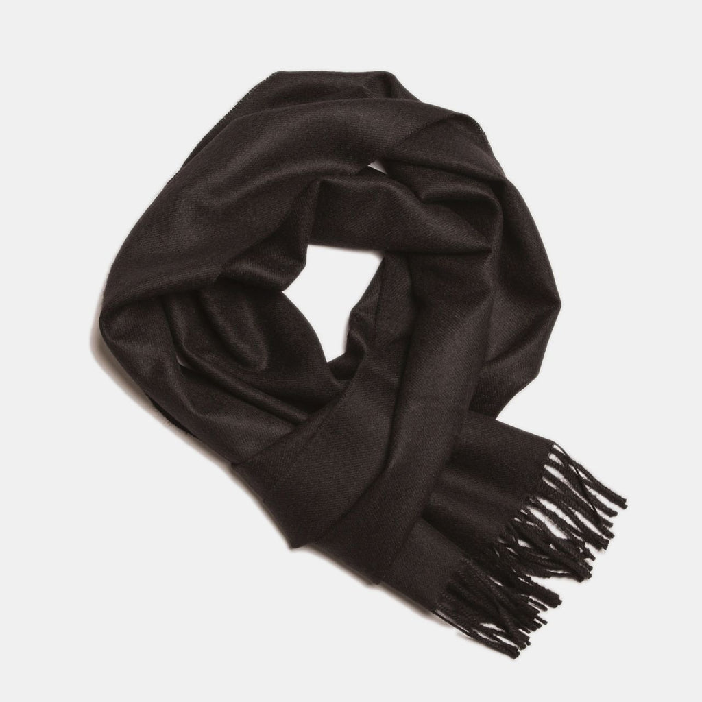 16. Black Alpaka baby alpaca wool scarf with fringe detail in flat lay