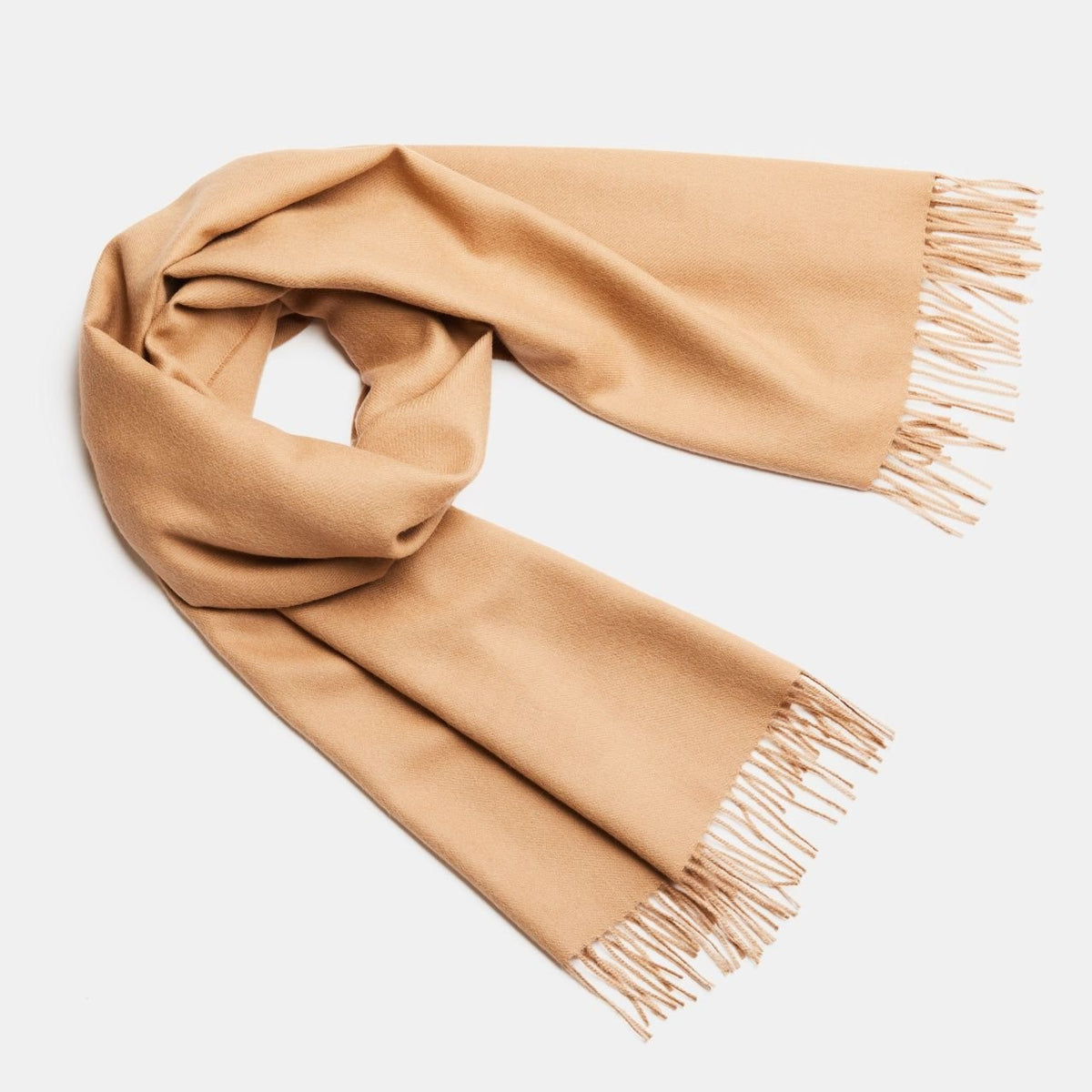 24. Studio shot of Alpaka natural baby alpaca maxi-scarf in camel with fringes, displayed in a rolled style