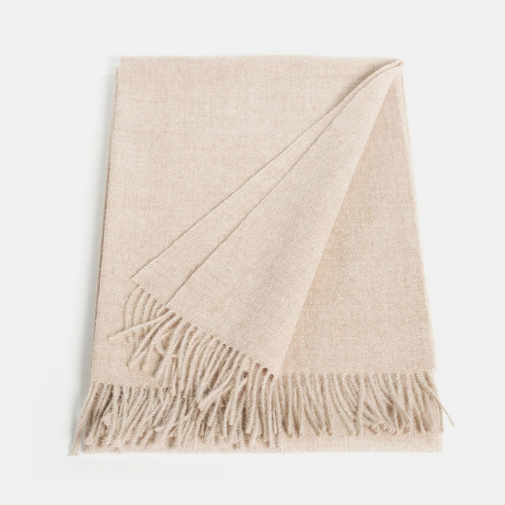 6. Flat lay of Alpaka natural baby alpaca maxi-scarf in beige with fringes, showing full length