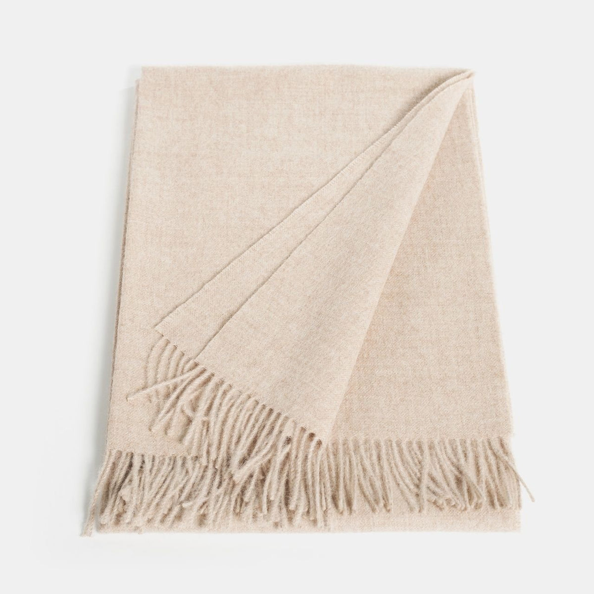 6. Flat lay of Alpaka natural baby alpaca maxi-scarf in beige with fringes, showing full length