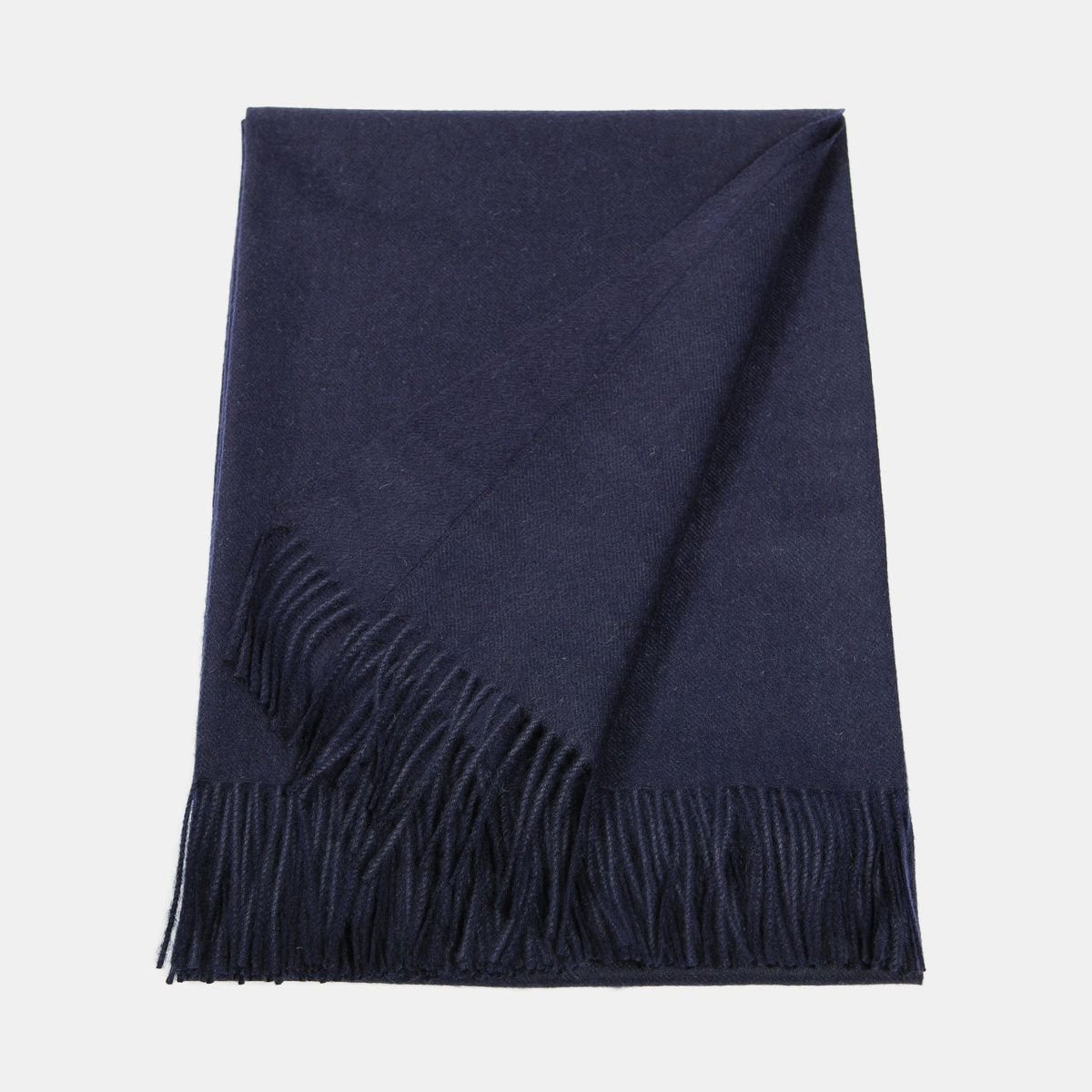16. Flat lay of Alpaka natural baby alpaca maxi-scarf in navy with fringes, showing full length