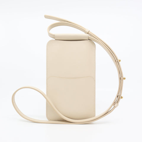 3. Side view of Tairi Roosve beige leather phone bag with adjustable strap and front pocket