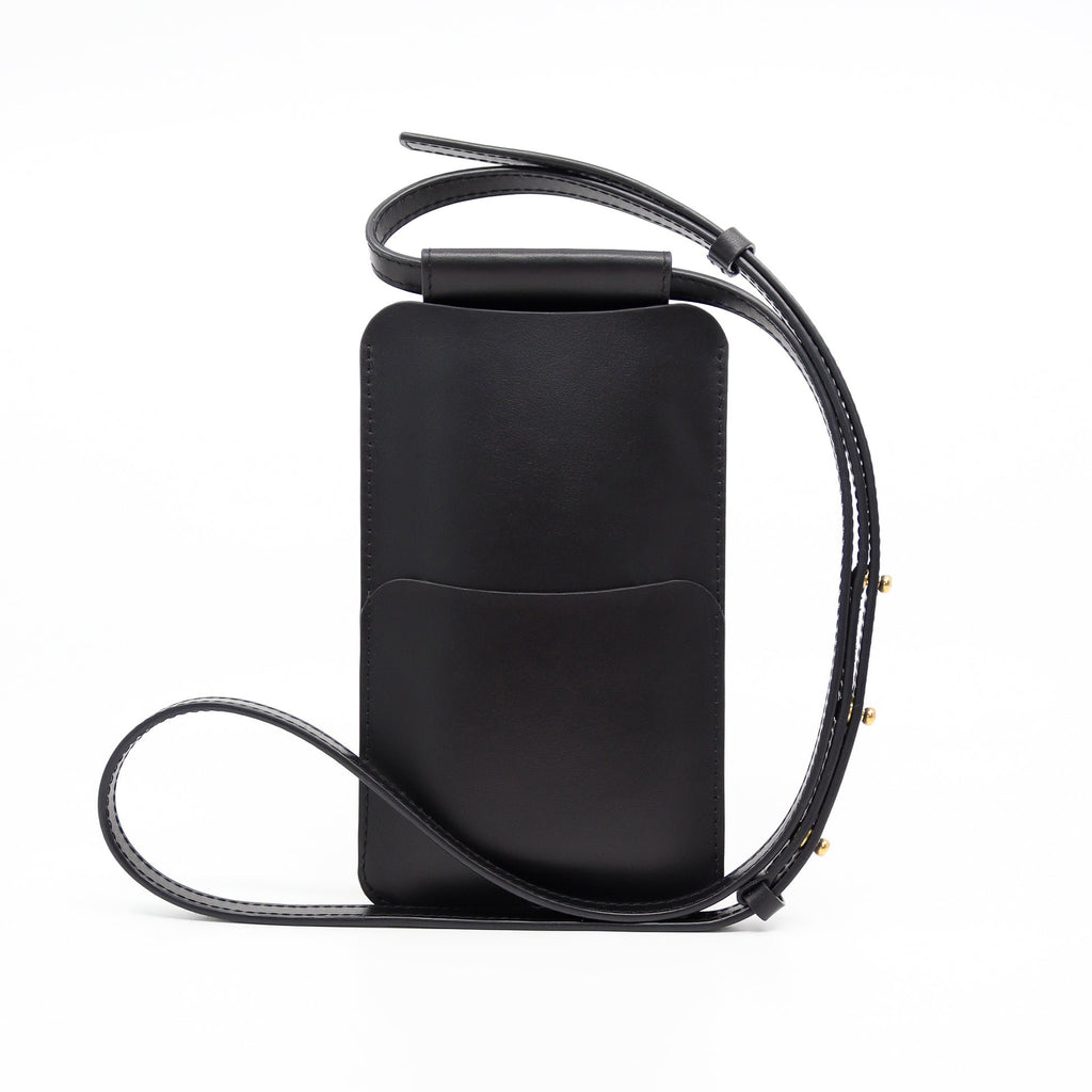 4. Back view of Tairi Roosve black leather phone bag showing front pocket and adjustable strap