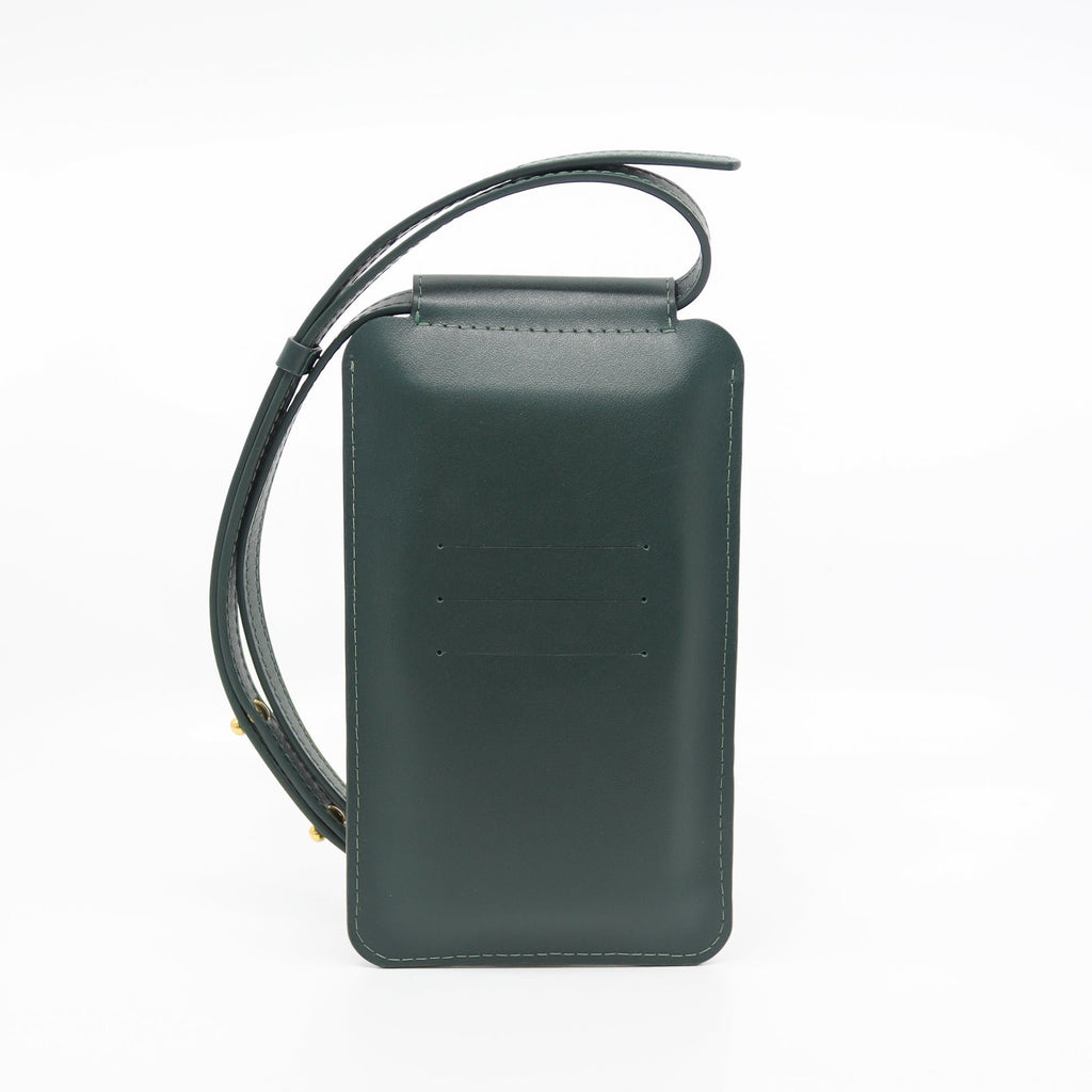 2. Studio image of Tairi Roosve leather phone bag in forest green, showing front view and adjustable strap