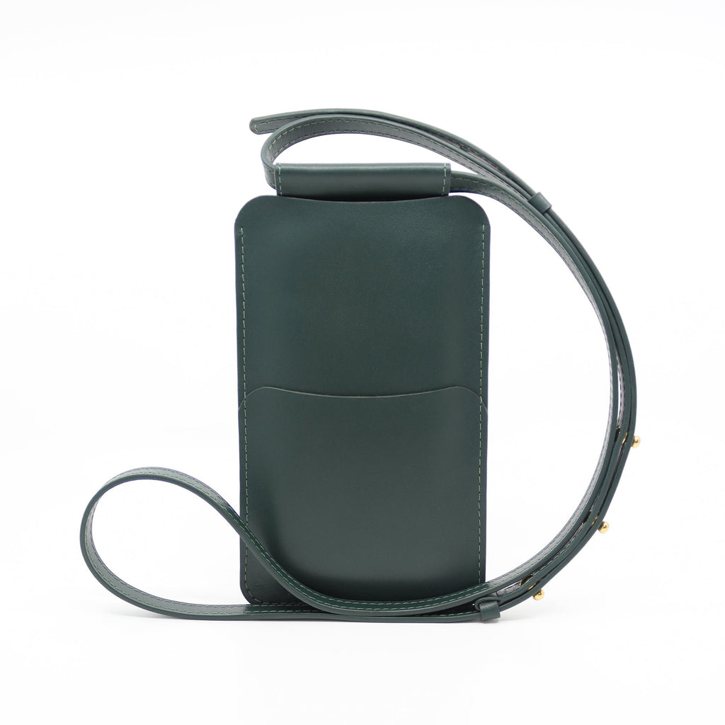 3. Studio image of Tairi Roosve leather phone bag in forest green, showing back pocket and strap detail