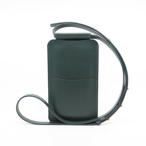 3. Studio image of Tairi Roosve leather phone bag in forest green, showing back pocket and strap detail