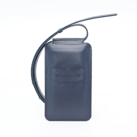 1. Tairi Roosve navy leather phone bag with adjustable strap and card slots, shown in studio