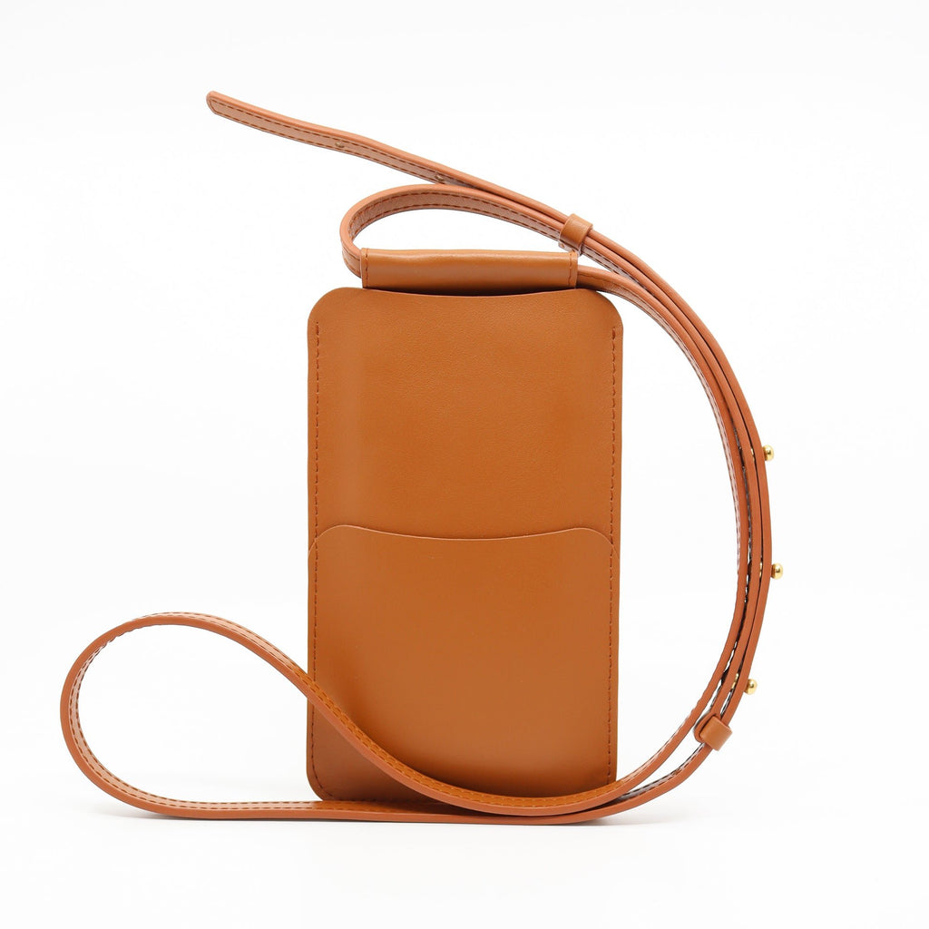 5. Side view of Tairi Roosve tan leather phone bag with adjustable strap and front pocket