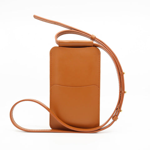 5. Side view of Tairi Roosve tan leather phone bag with adjustable strap and front pocket