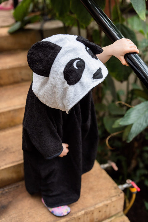 2. Close-up of toddler in RÄTT panda poncho, highlighting panda hood design