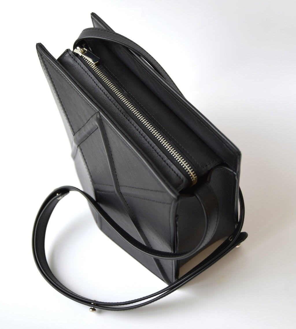 13. Black FACET shoulder bag by Gerda Retter Design, shown from a top angle with a focus on the strap