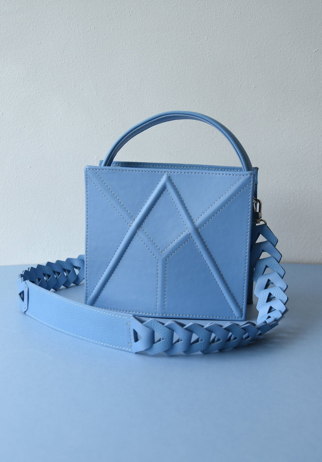 10. Light blue FACET shoulder bag by Gerda Retter Design, displayed with a matching strap in a studio setting