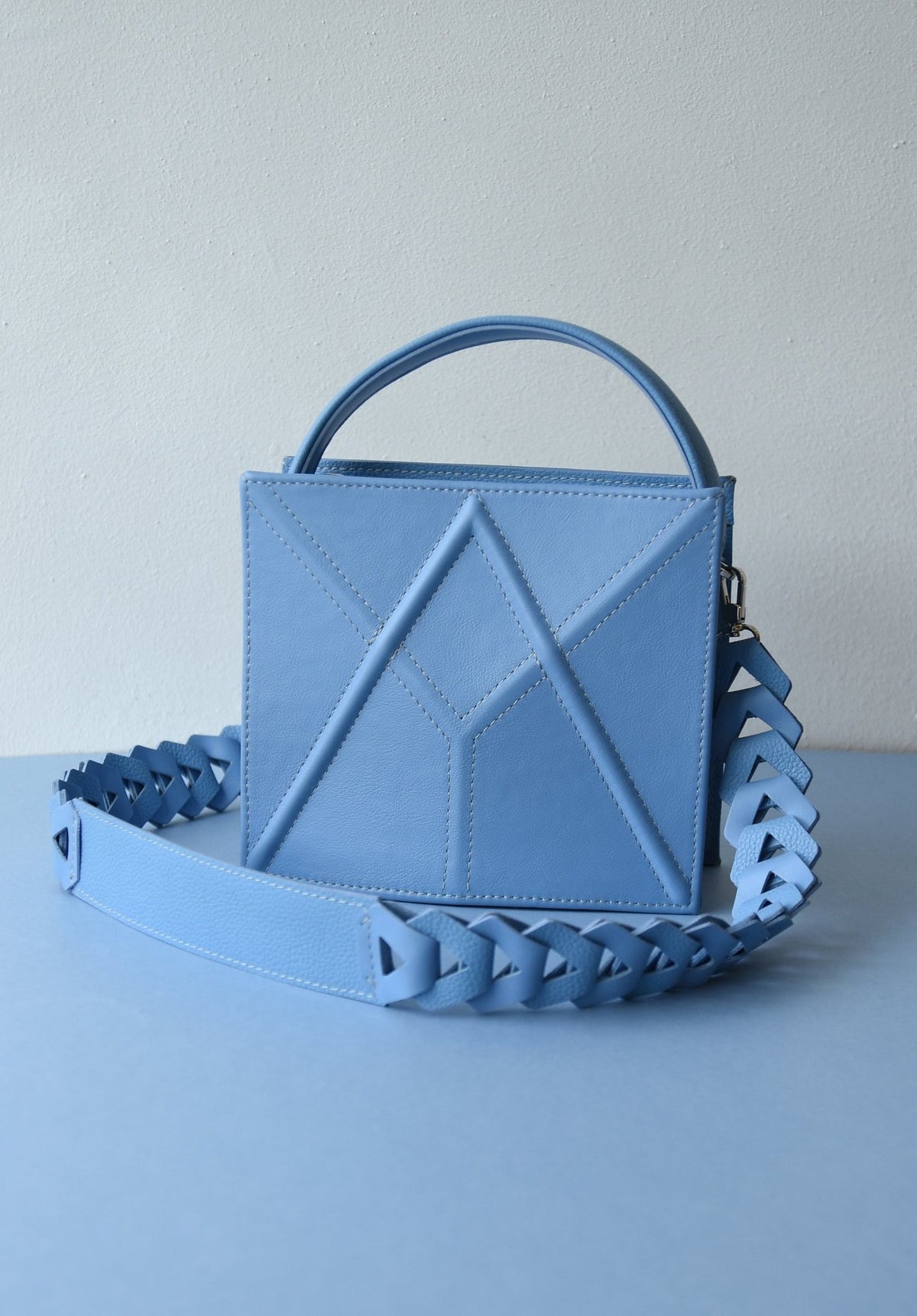 10. Light blue FACET shoulder bag by Gerda Retter Design, displayed with a matching strap in a studio setting