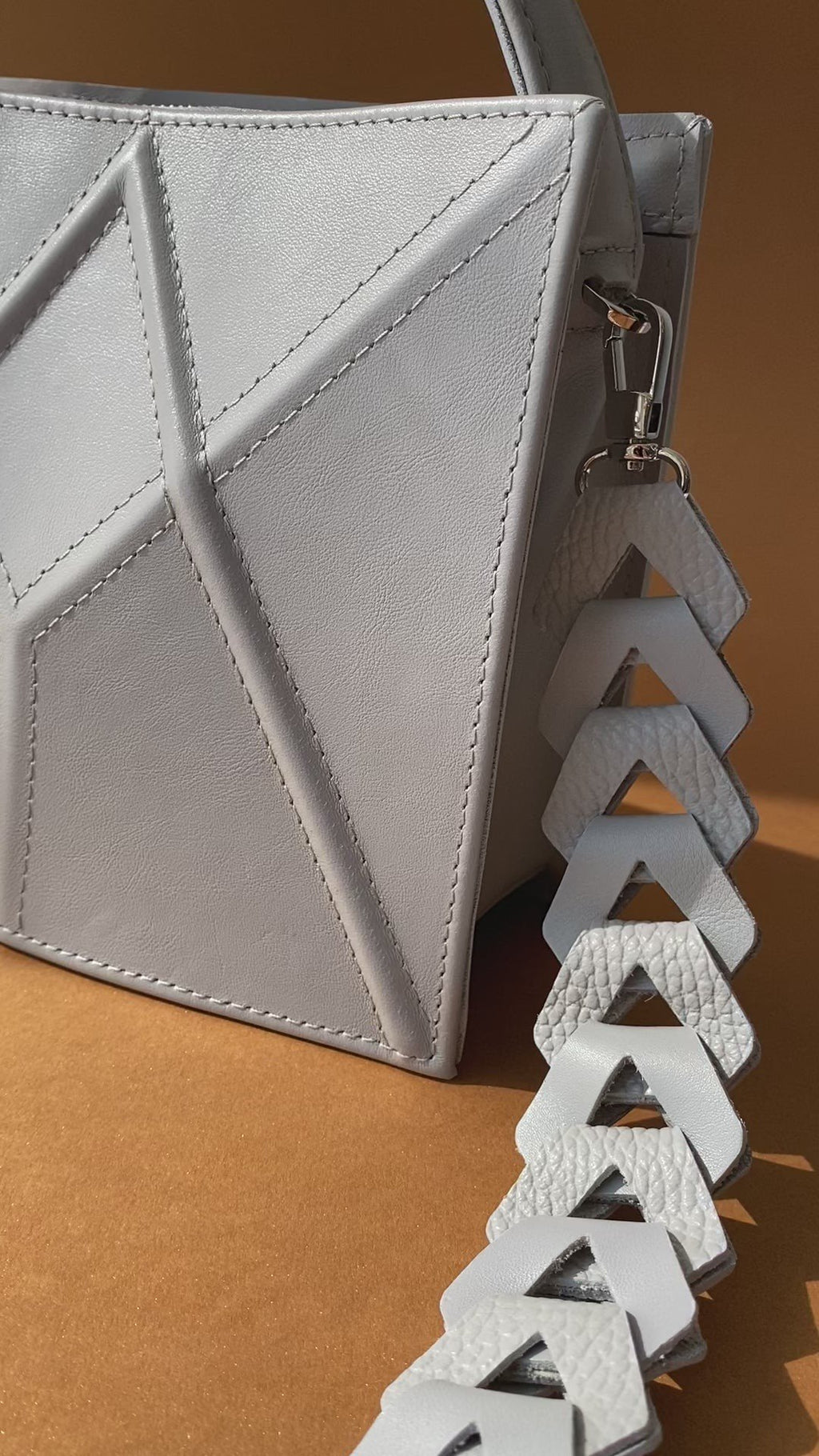 6. Close-up of light grey FACET shoulder bag by Gerda Retter Design, highlighting the strap detail
