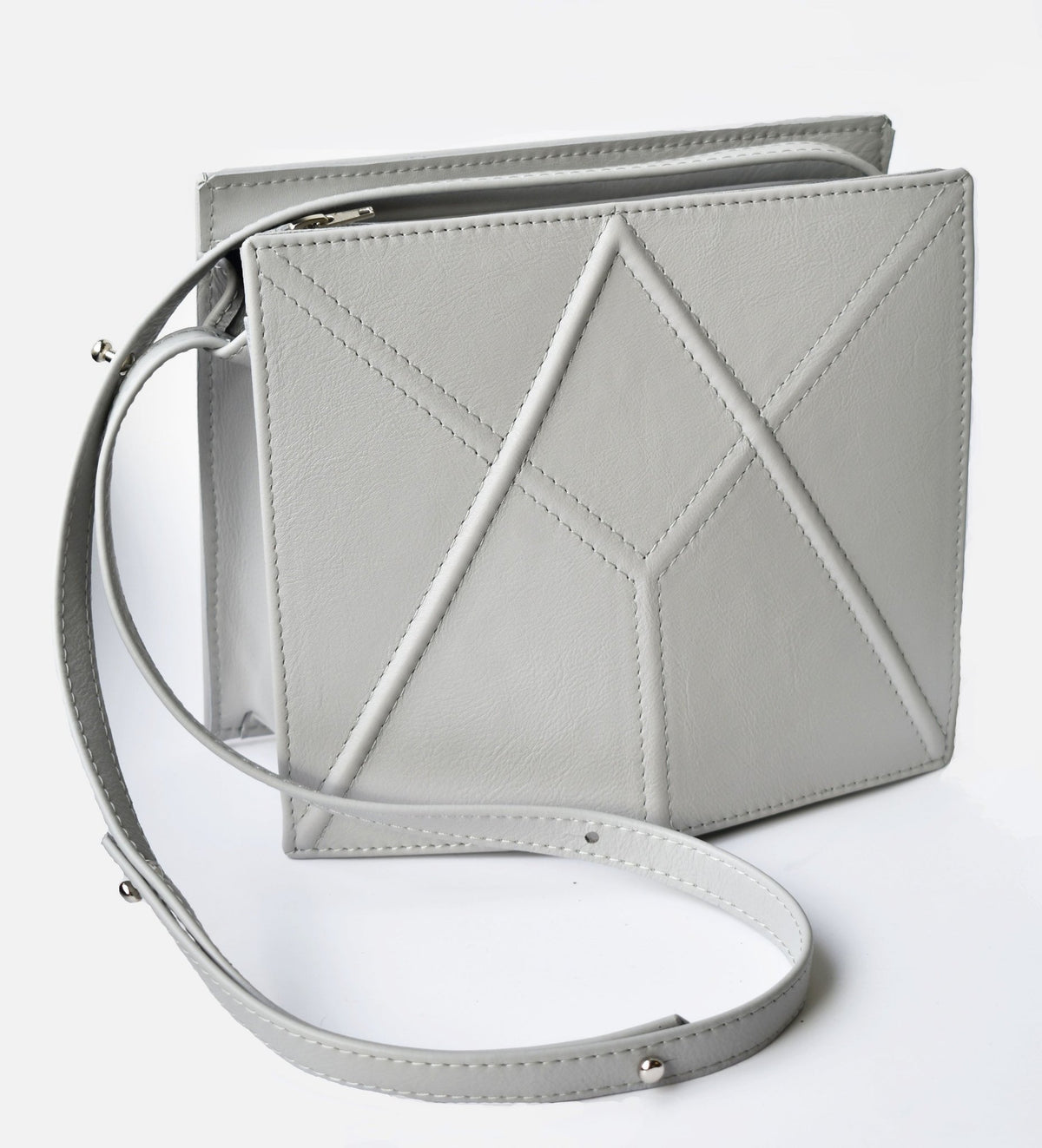 5. Light grey FACET shoulder bag by Gerda Retter Design, shown with a removable strap in a studio setting