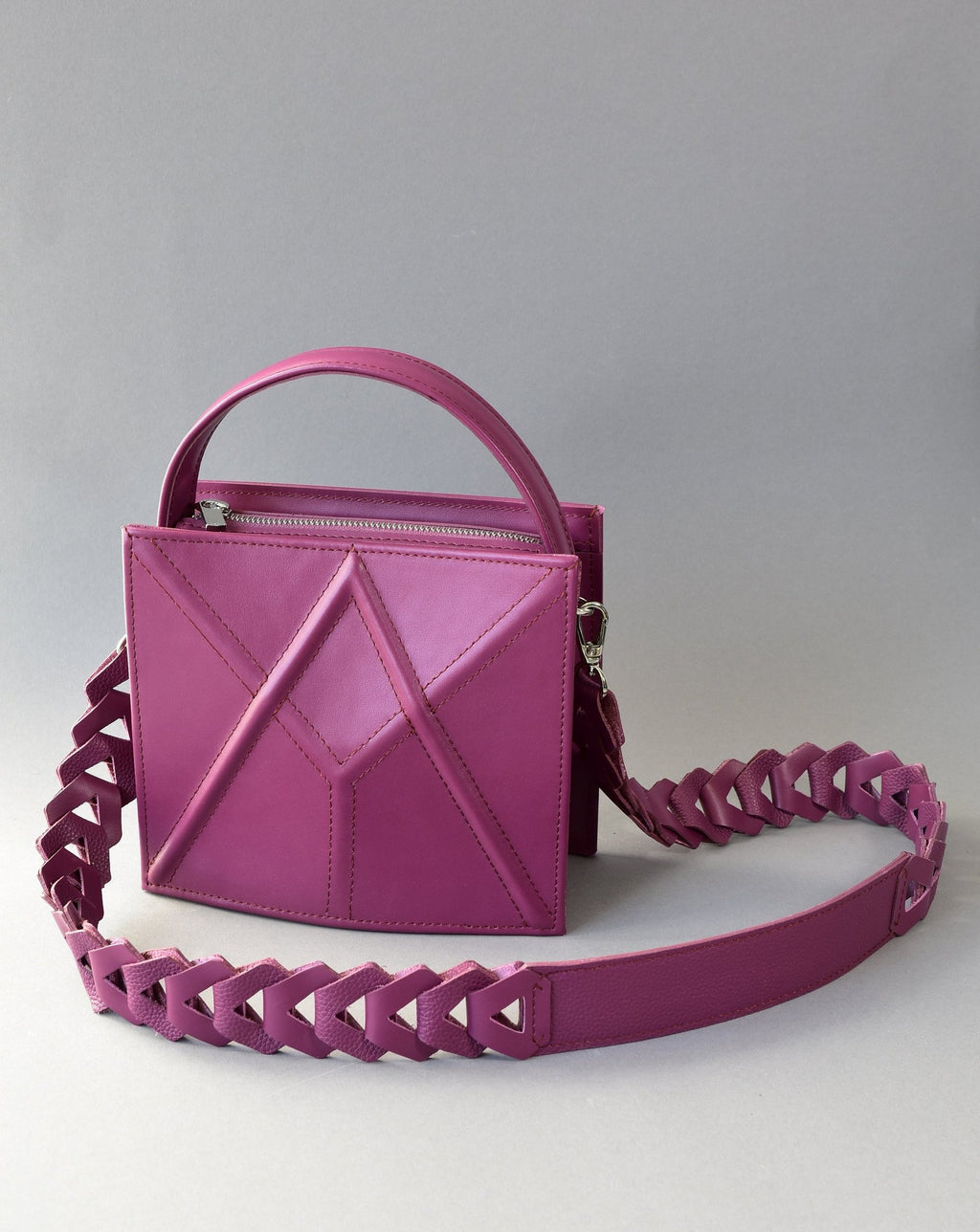 8. Purple FACET shoulder bag by Gerda Retter Design, shown with a decorative strap in a studio setting