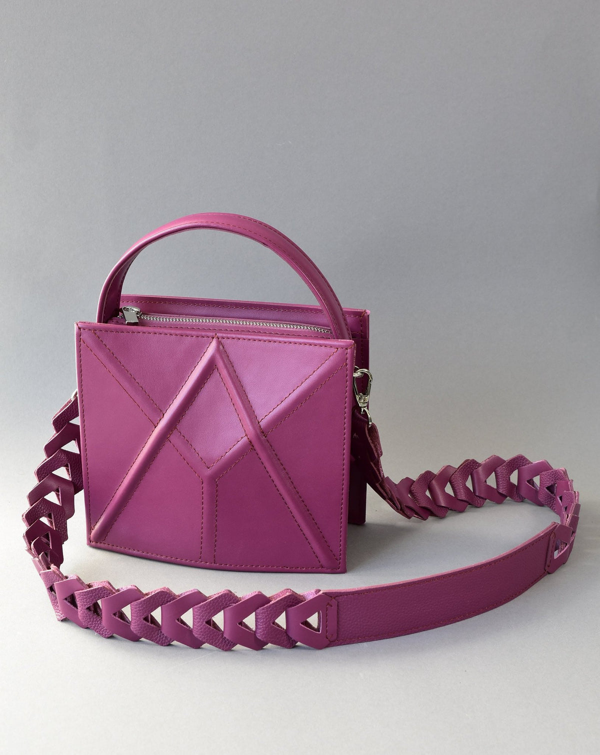 8. Purple FACET shoulder bag by Gerda Retter Design, shown with a decorative strap in a studio setting