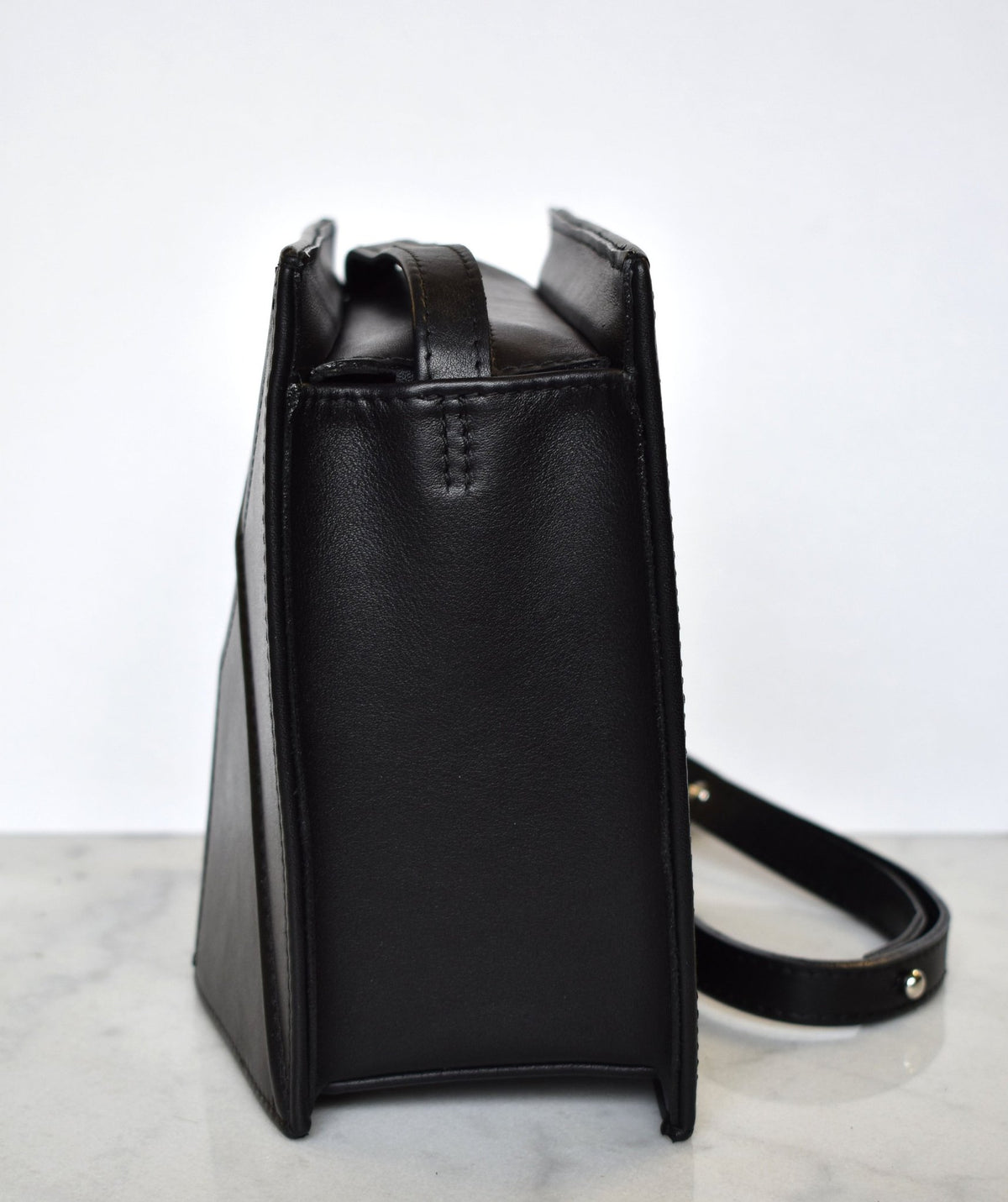 14. Side view of black FACET shoulder bag by Gerda Retter Design, highlighting the leather texture