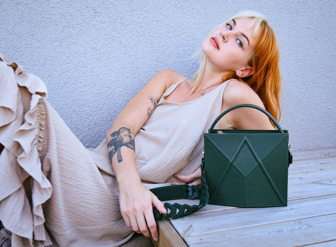 1. Women's green FACET shoulder bag by Gerda Retter Design, styled with a beige dress in a lifestyle setting