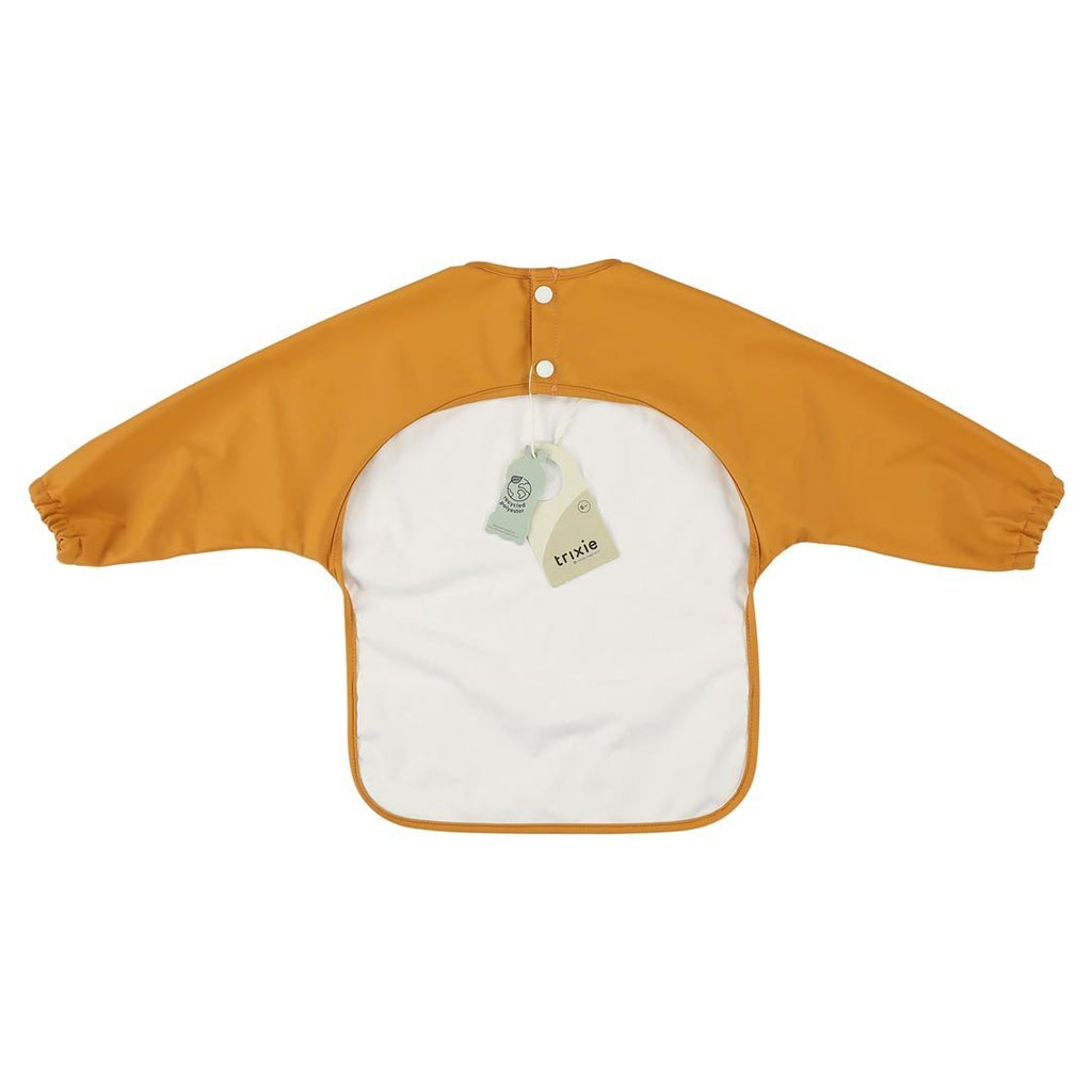 2. Back view of orange Trixie Baby waterproof long sleeve bib with white lining and snap closures