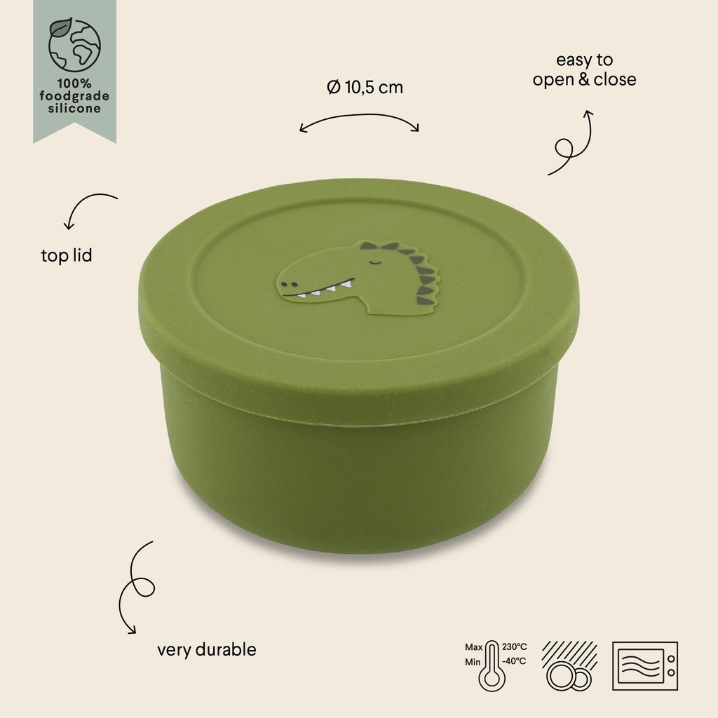 2. Green silicone snack container with dinosaur design, labeled features including easy open lid and durability, by Trixie Baby