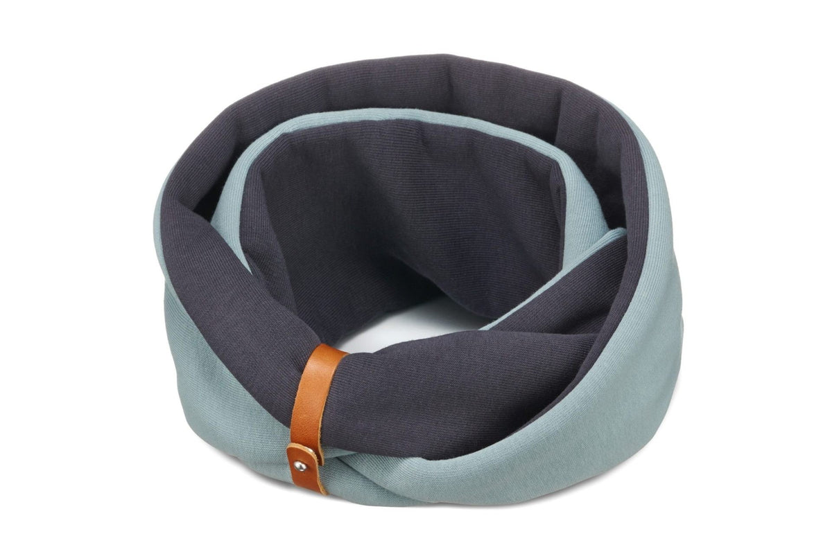 2. Studio shot of Labbvenn Simo neck warmer in turquoise and iron with brown leather belt, highlighting cotton and polyester blend fabric