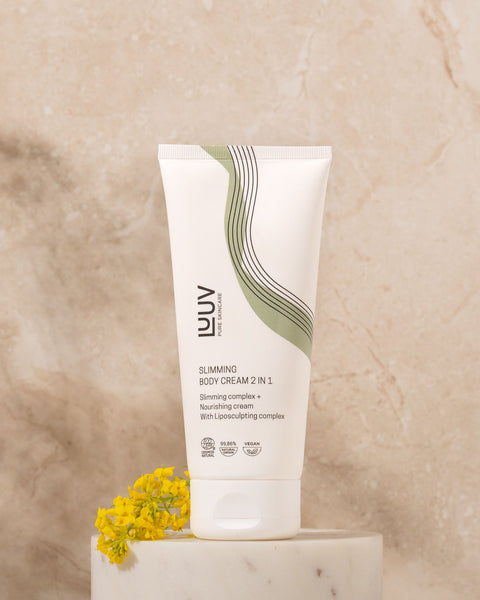 1. LUUV Slimming Body Cream 2 in 1 on marble surface with yellow flowers, highlighting eco-friendly packaging