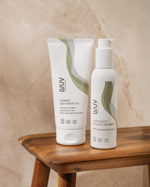 5. LUUV Slimming Body Cream and Curve Sculpt Cellulite Treatment on wooden stool, emphasizing minimalist packaging