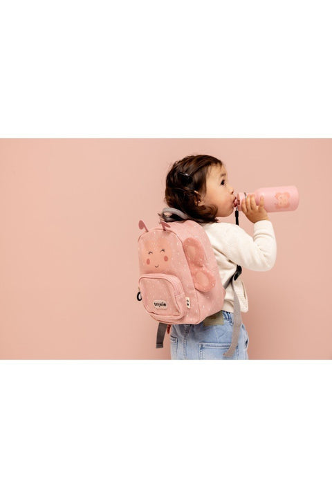 1. Child wearing pink Trixie Baby Mrs. Butterfly backpack while drinking from a bottle