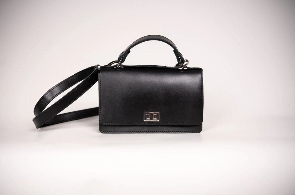 2. Studio shot of Zelma Kraft black small briefcase handbag with silver clasp and adjustable strap