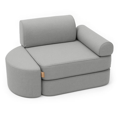 1. Fog gray children's modular sofa with semicircular footstool, armrest, and headrest in studio setting