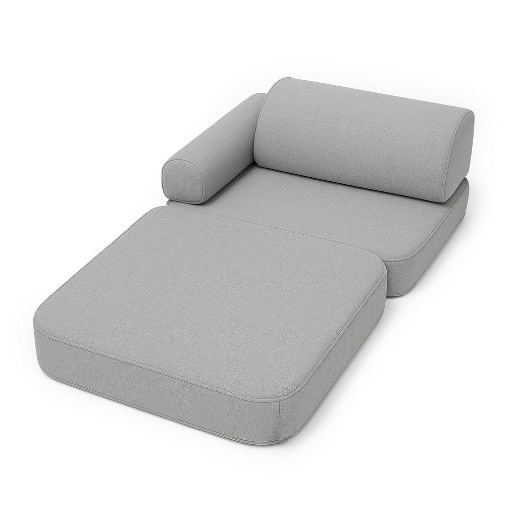3. Fog gray children's modular sofa laid flat as a lounger with armrest in studio setting