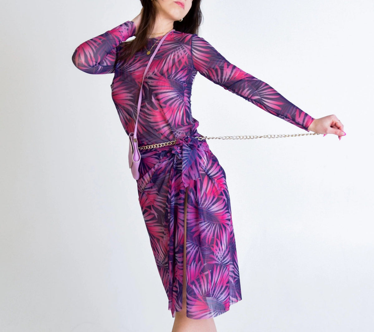 3. Women's pink Tropica tan-through long-sleeve shirt and matching skirt, styled with chain belt in studio