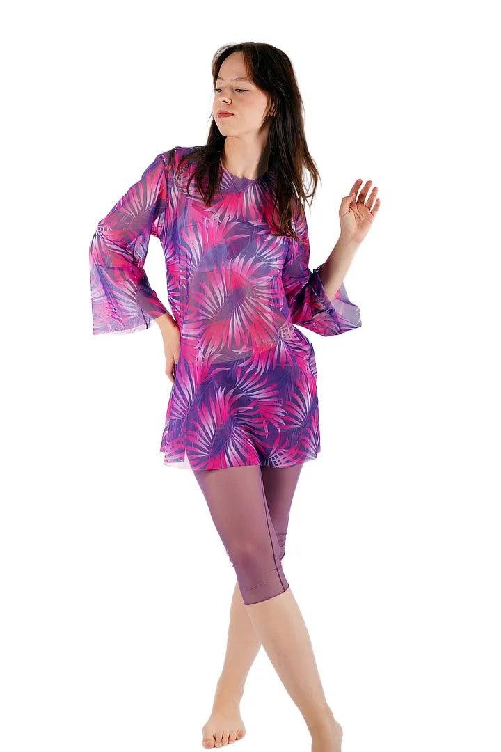 1. Women's Tan-Through Tunic in Pink Tropics by Smarttan, worn by model in studio setting