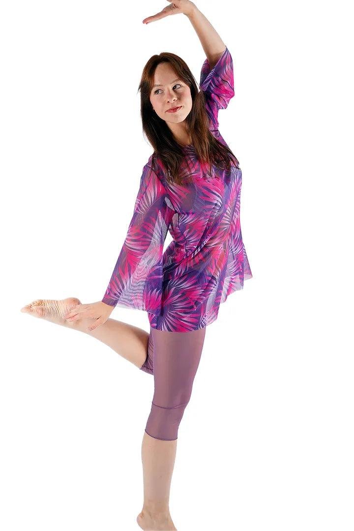 3. Women's Tan-Through Tunic in Pink Tropics by Smarttan, shown in dynamic pose in studio