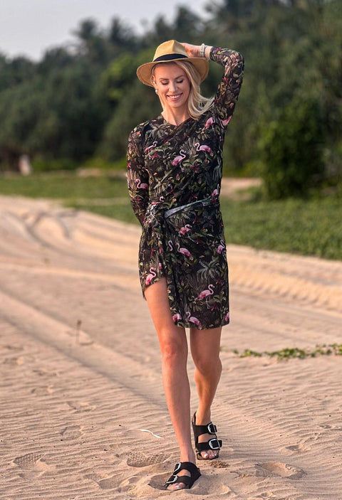 4. Woman posing in Eeva Tropics Tan Through Sarong by Smarttan, showing the sarong's elegant drape and sun protection features