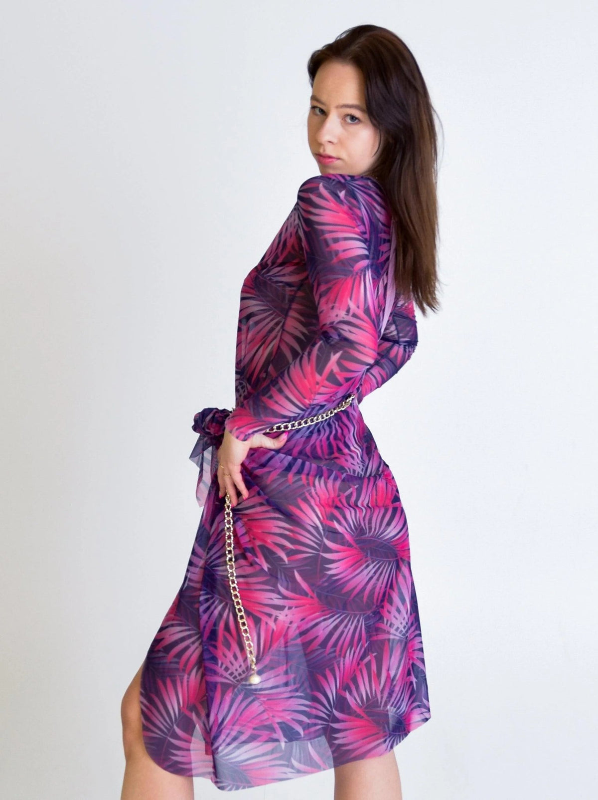 2. Side view of women's Pink Tropics Tan Through Sarong by Smarttan, highlighting tropical print and lightweight fabric in studio