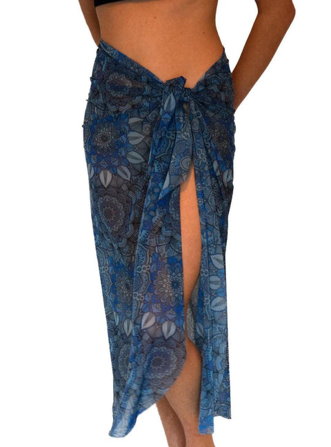 1. Women's blue-purple Mandala Tan Through Sarong by Smarttan, shown tied at the waist, highlighting the vibrant mandala pattern and lightweight fabric, perfect for beachwear.