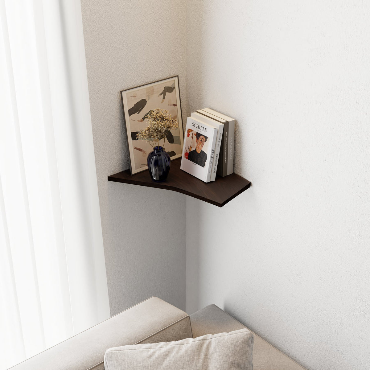7. Smoked oak corner shelf in living room corner, displaying books, art, and a vase above a sofa