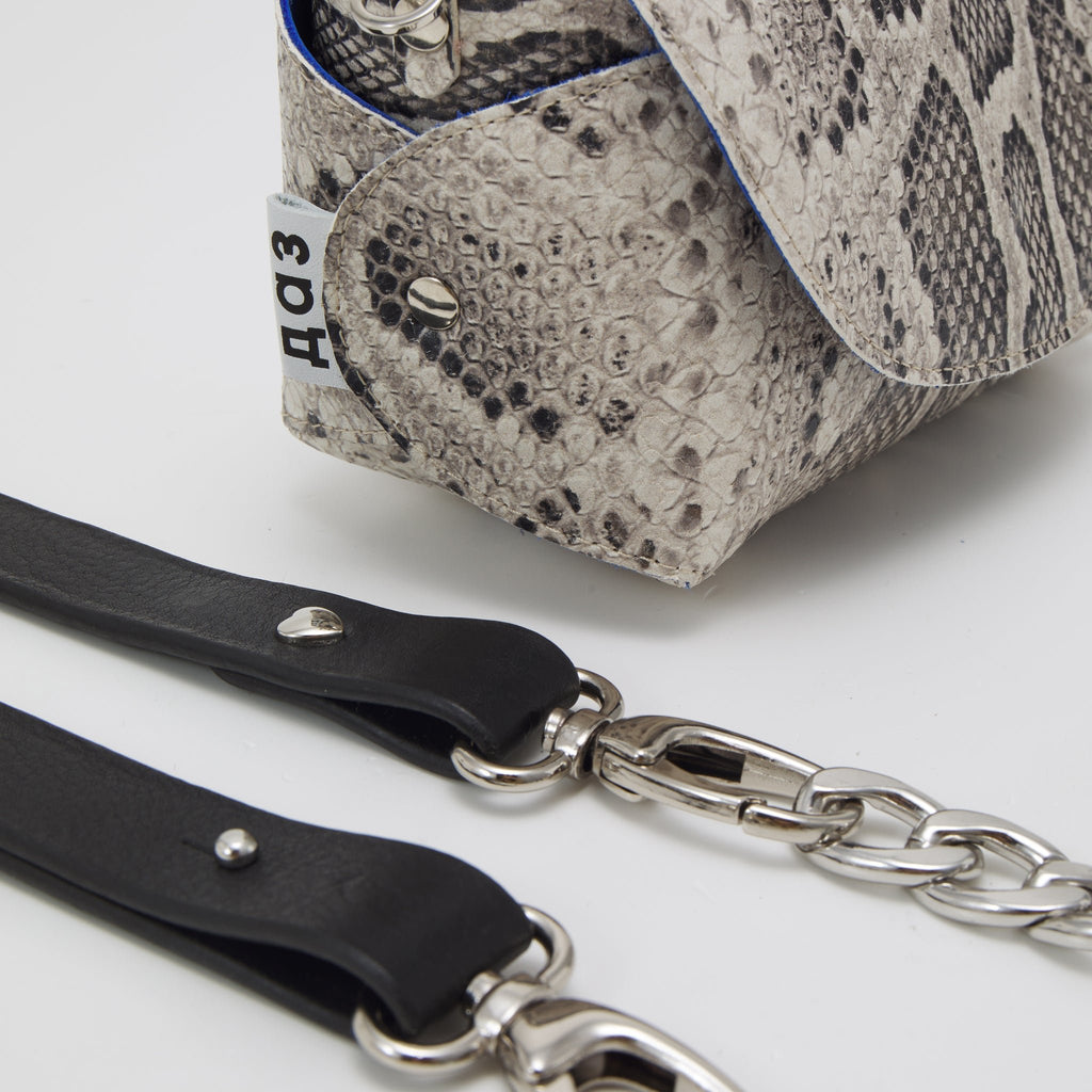 6. Close-up of Daz Studio snake print leather bag with detachable straps and silver chain detail